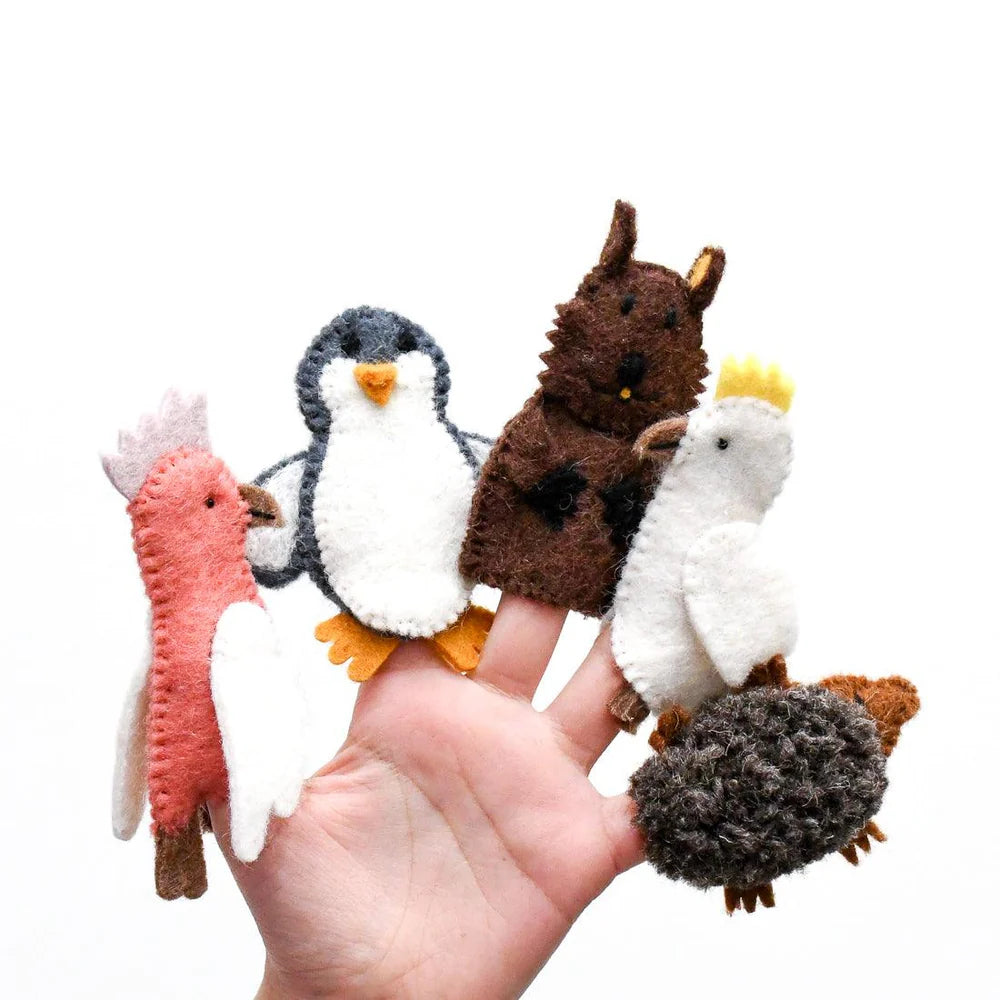 Set of animal finger puppets held by a hand on a white background