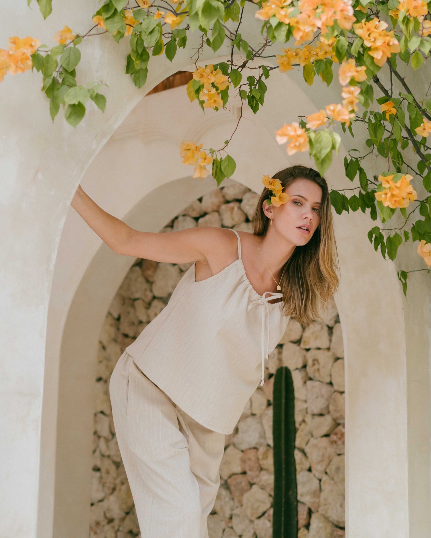 Luma Top – singlet-style summer top with adjustable tie-up front and cowrie shell detailing.