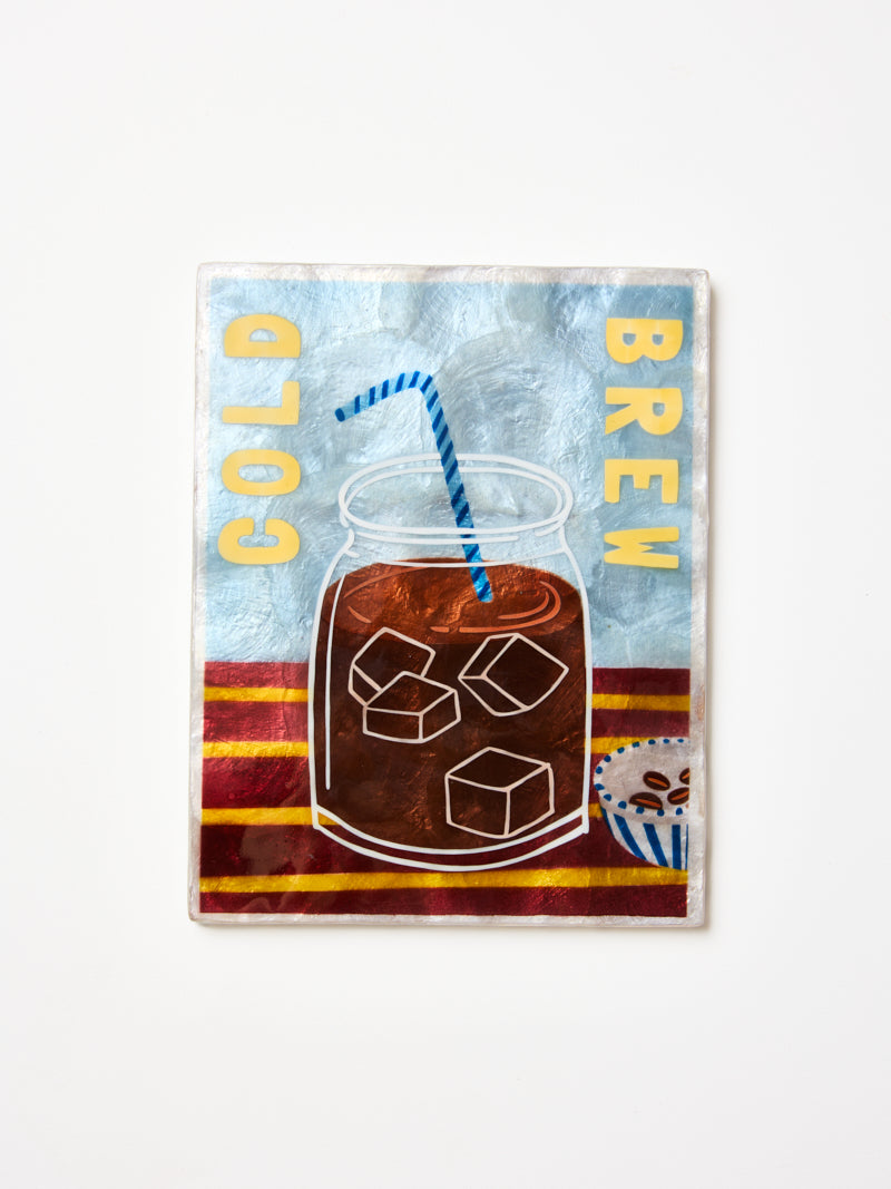 Wall art with a design of a glass of iced coffee, straw, and text 'Cold Brew' on a blue and red striped background.