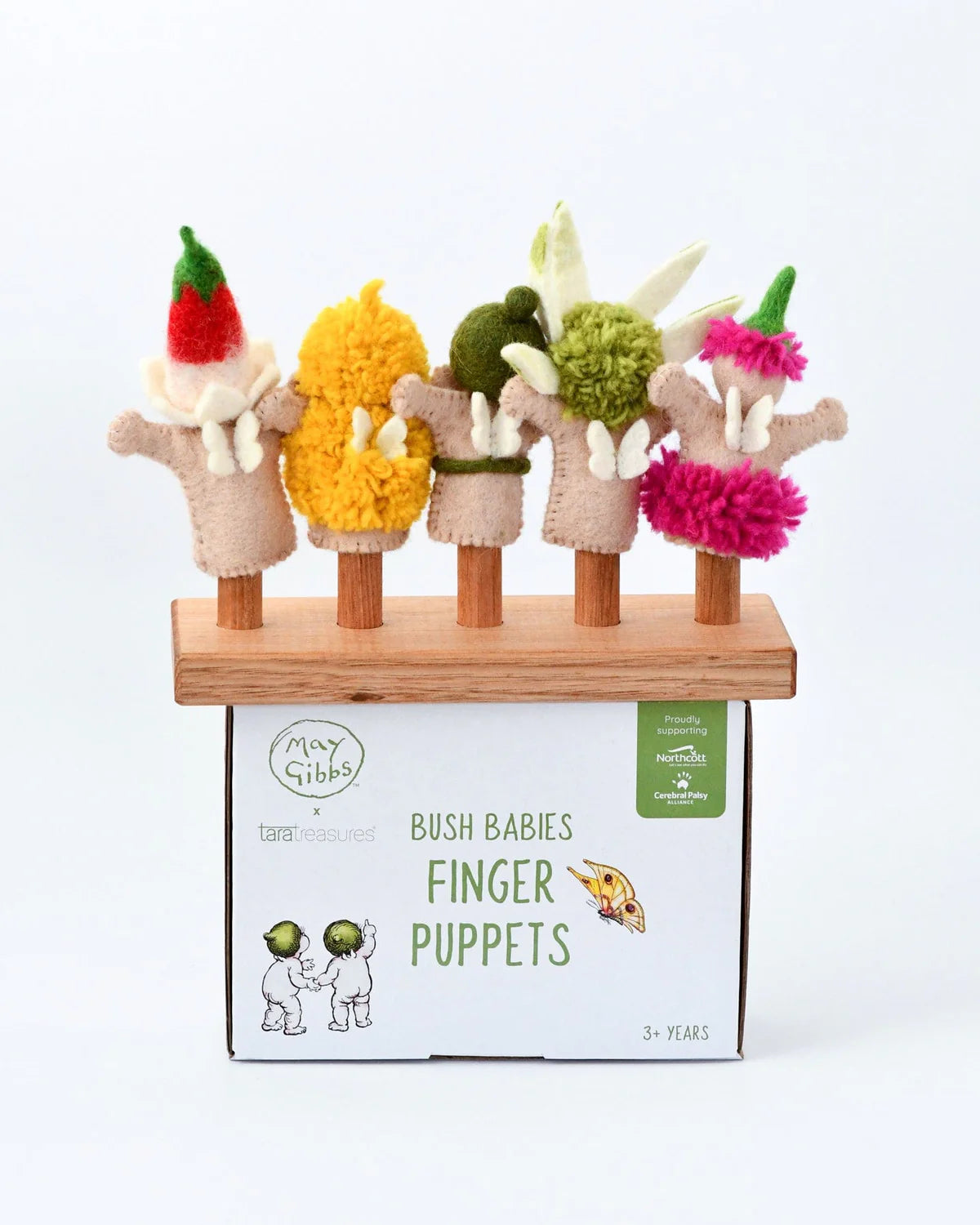 Set of finger puppets with colorful pom-pom heads on a stand, in front of their packaging box.