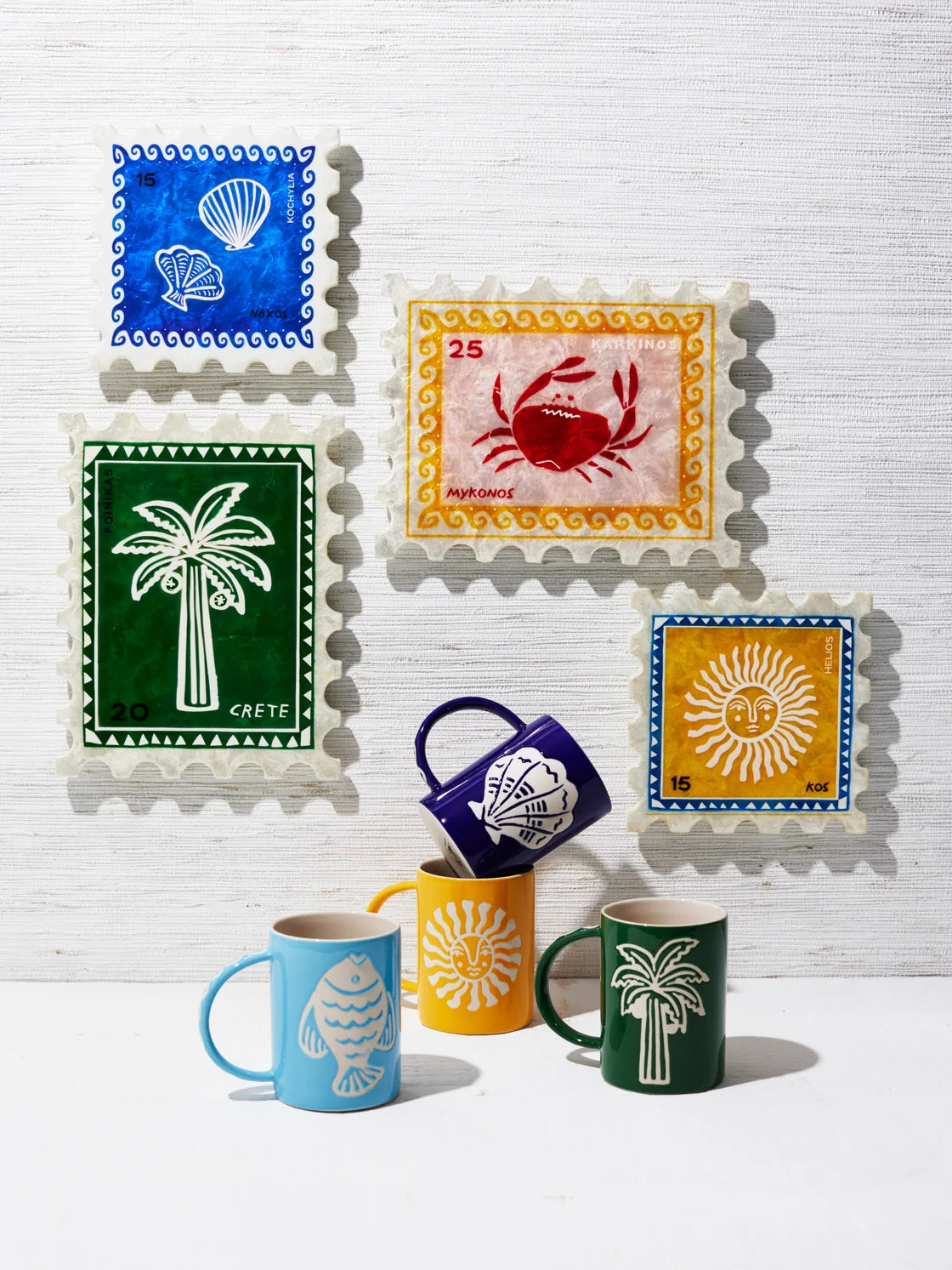 Colorful mugs with decorative designs on a white background